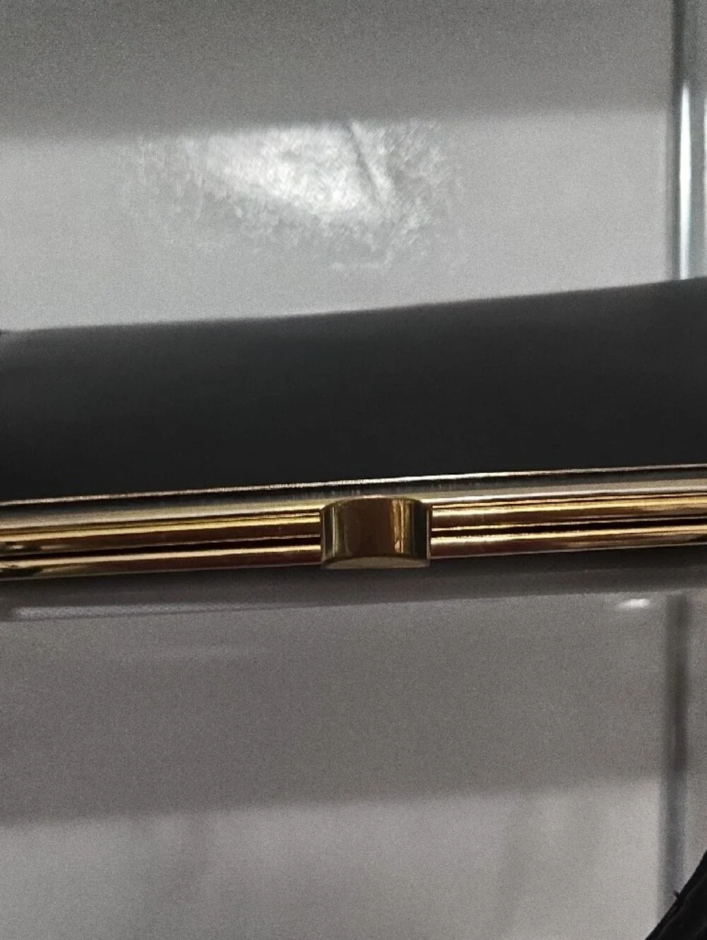 Structured Black Leather Frame Wristlet with Gold Accent